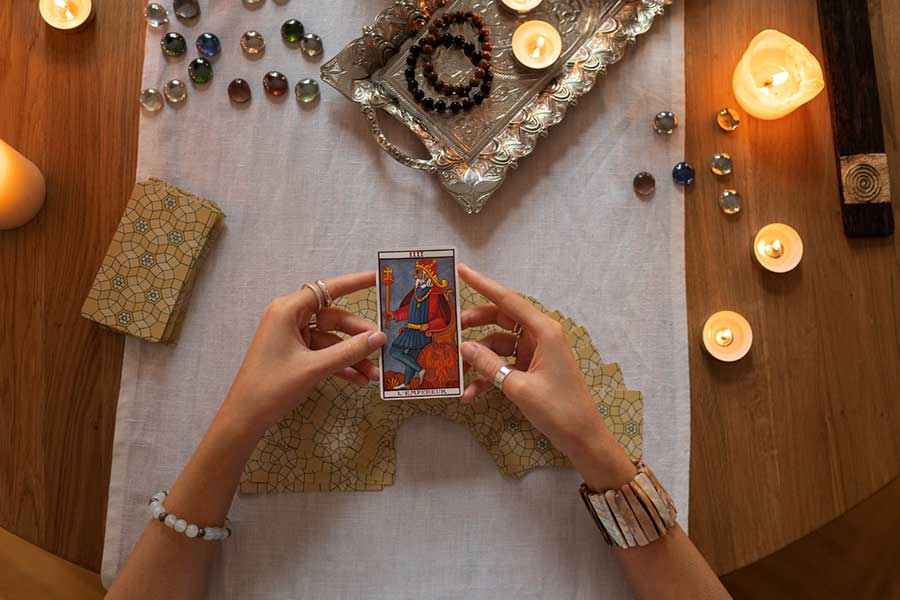 Tarot card reading with candles and crystals